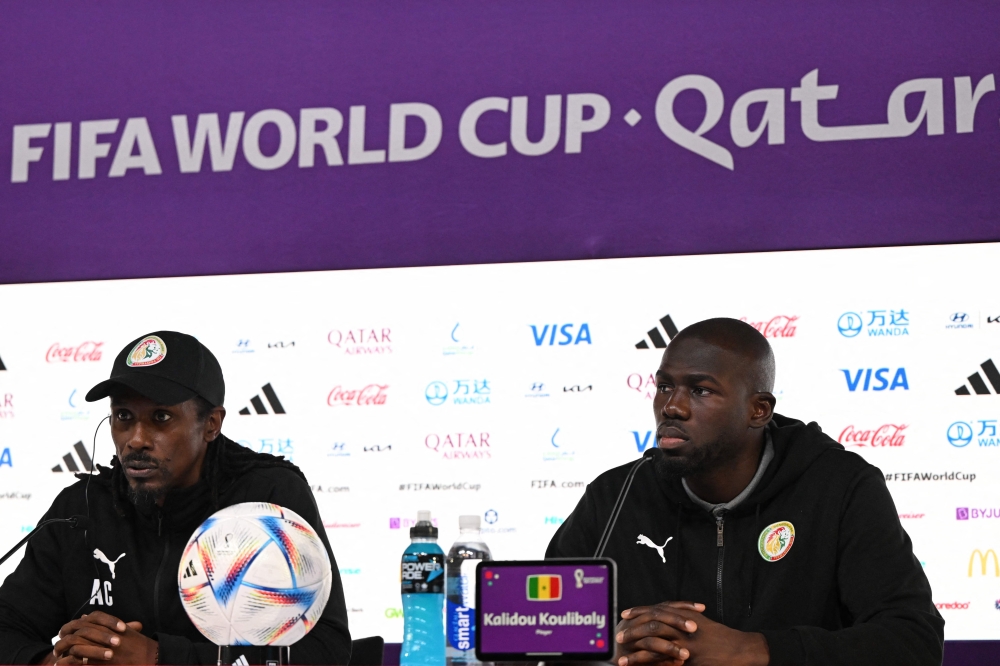 Senegal's coach Aliou Cisse (left) and Senegal's defender Kalidou Koulibaly attend a press conference at the Qatar National Convention Center (QNCC) in Doha on November 24, 2022, on the eve of the Qatar 2022 World Cup football match between Qatar and Senegal. (Photo by OZAN KOSE / AFP)