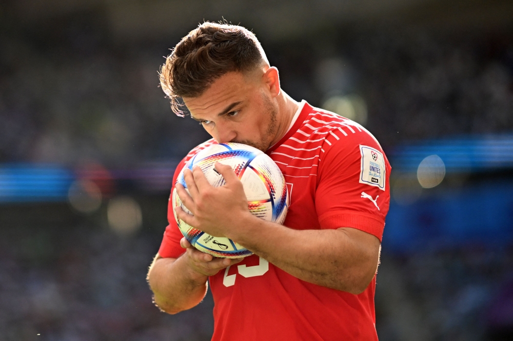 Switzerland's midfielder #23 Xherdan Shaqiri kisses the ball during the Qatar 2022 World Cup Group G football match between Switzerland and Cameroon at the Al-Janoub Stadium in Al-Wakrah, south of Doha on November 24, 2022. (Photo by Kirill KUDRYAVTSEV / AFP)