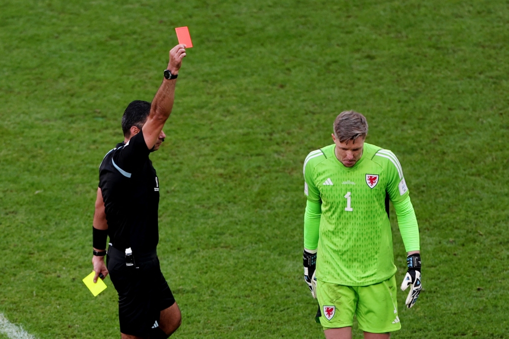 Wales' Wayne Hennessey is shown a red card by referee Mario Escobar REUTERS/Marko Djurica