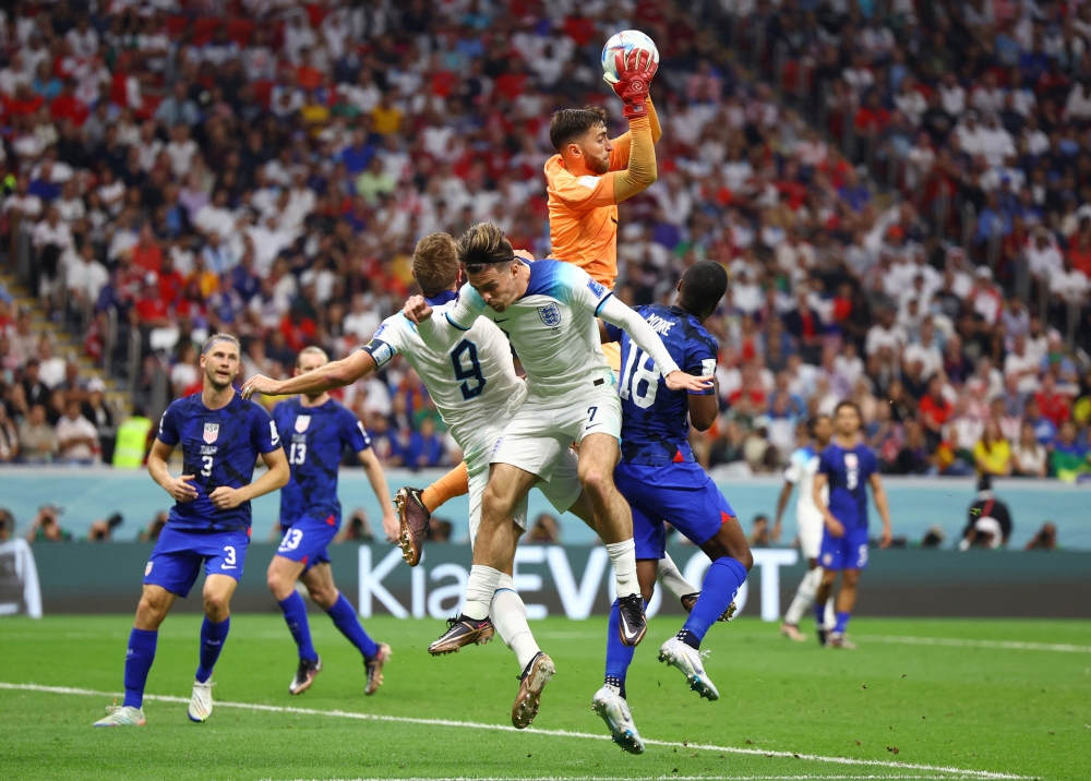 Matt Turner and Shaq Moore of the United States in action with England's Jack Grealish and Harry Kane during the Qatar 2022 World Cup Group B football match between England and the United States at Al Bayt Stadium on November 25, 2022. (REUTERS/Kai Pfaffenbach)