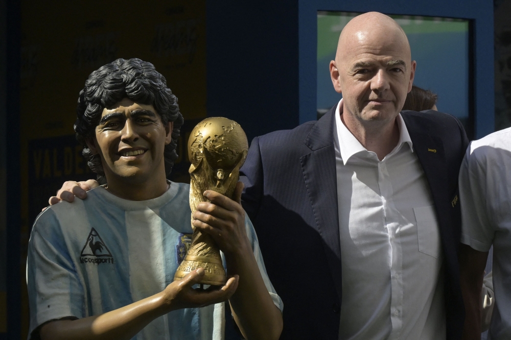 FIFA President Gianni Infantino poses during a tribute ceremony to late football star Diego Maradona on the 2nd anniversary of his death at CONMEBOL fan zone 'Tree of dreams' during the Qatar 2022 World Cup football tournament in Doha on November 25, 2022. (Photo by JUAN MABROMATA / AFP)