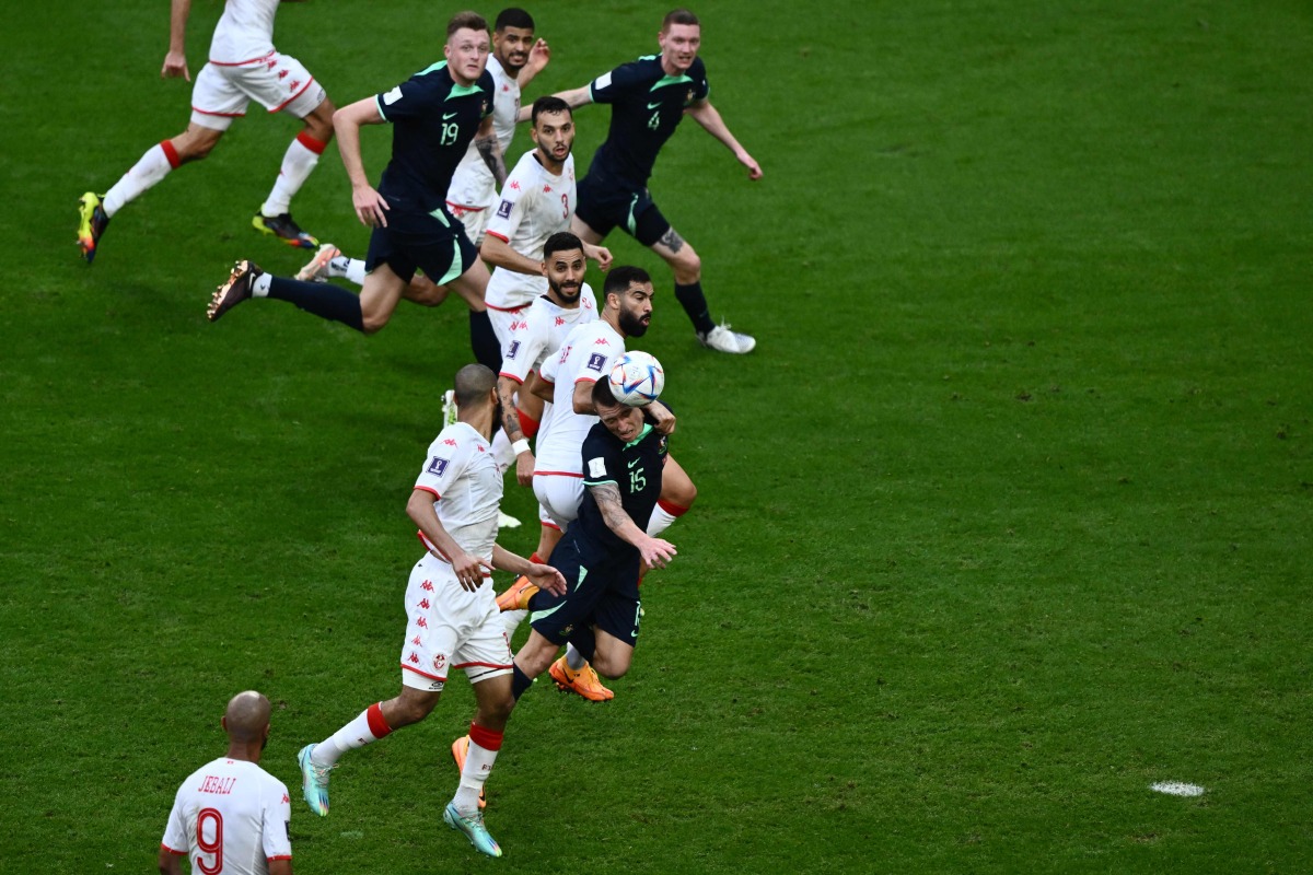 Australia’s Mitchell Duke (3rd bottom) heads the ball during their Group D match against Tunisia at the Al Janoub Stadium. AFP