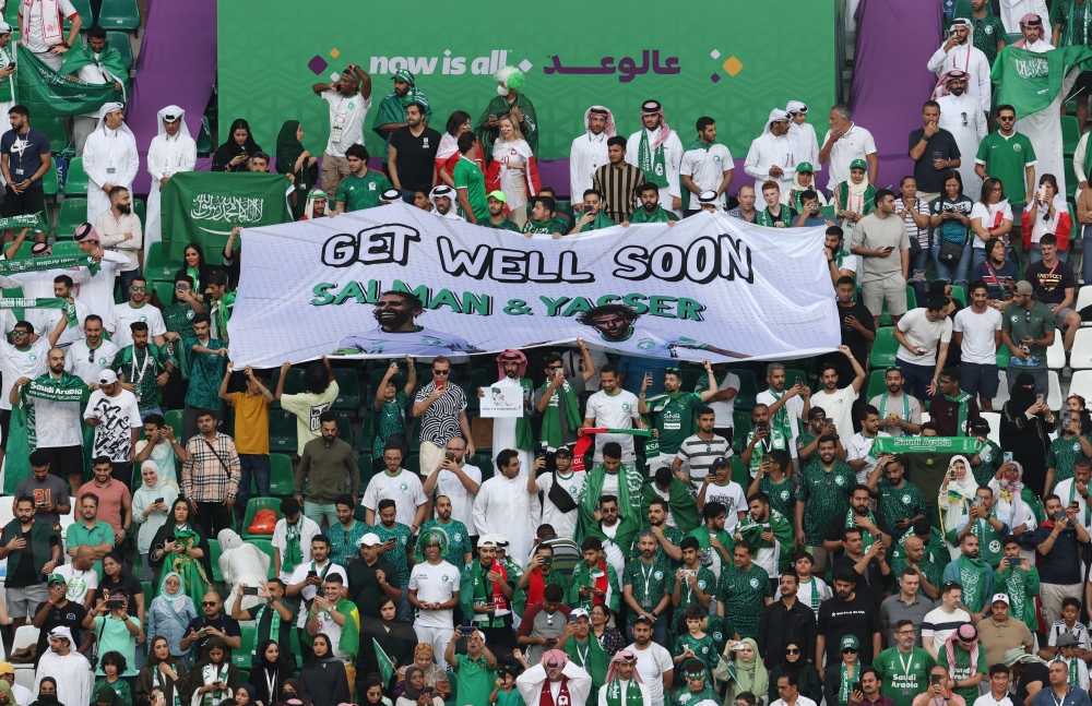 Saudi Arabia fans with a banner in support of Salman Al-Faraj and Yasser Al-Shahrani inside the Education City Stadium in Qatar, before the match against Poland on November 26, 2022. (REUTERS/Molly Darlington)