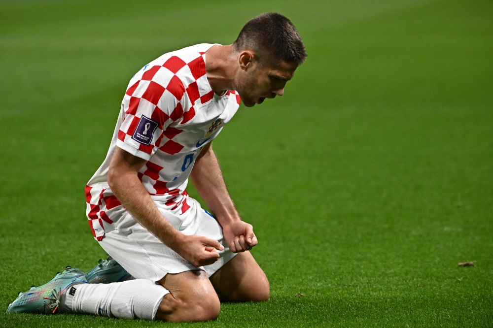 Croatia's forward #09 Andrej Kramaric celebrates scoring his team's first goal during the Qatar 2022 World Cup Group F football match between Croatia and Canada at the Khalifa International Stadium in Doha on November 27, 2022. (Photo by Anne-Christine POUJOULAT / AFP)