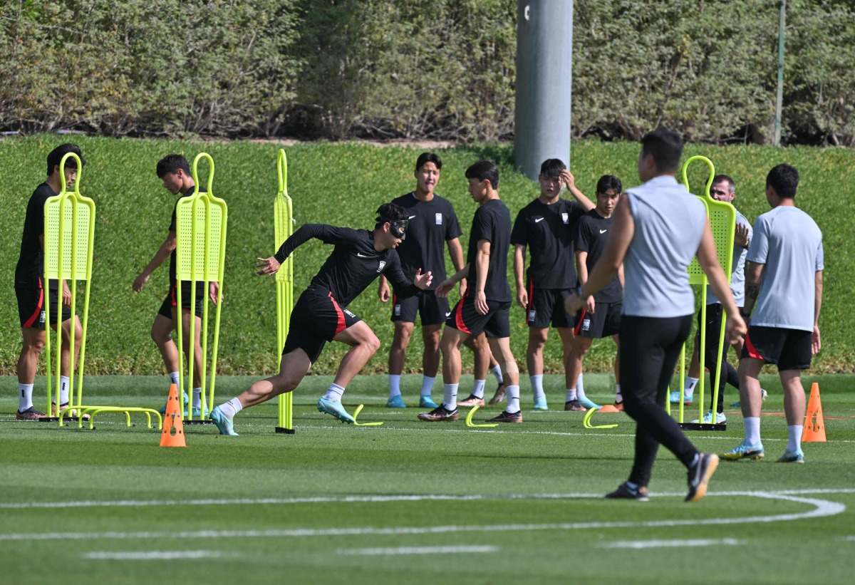 South Korea’s midfielder Son Heung-min (in mask) trains with teammates at the Al Egla Training Site 5 in Doha, yesterday. AFP