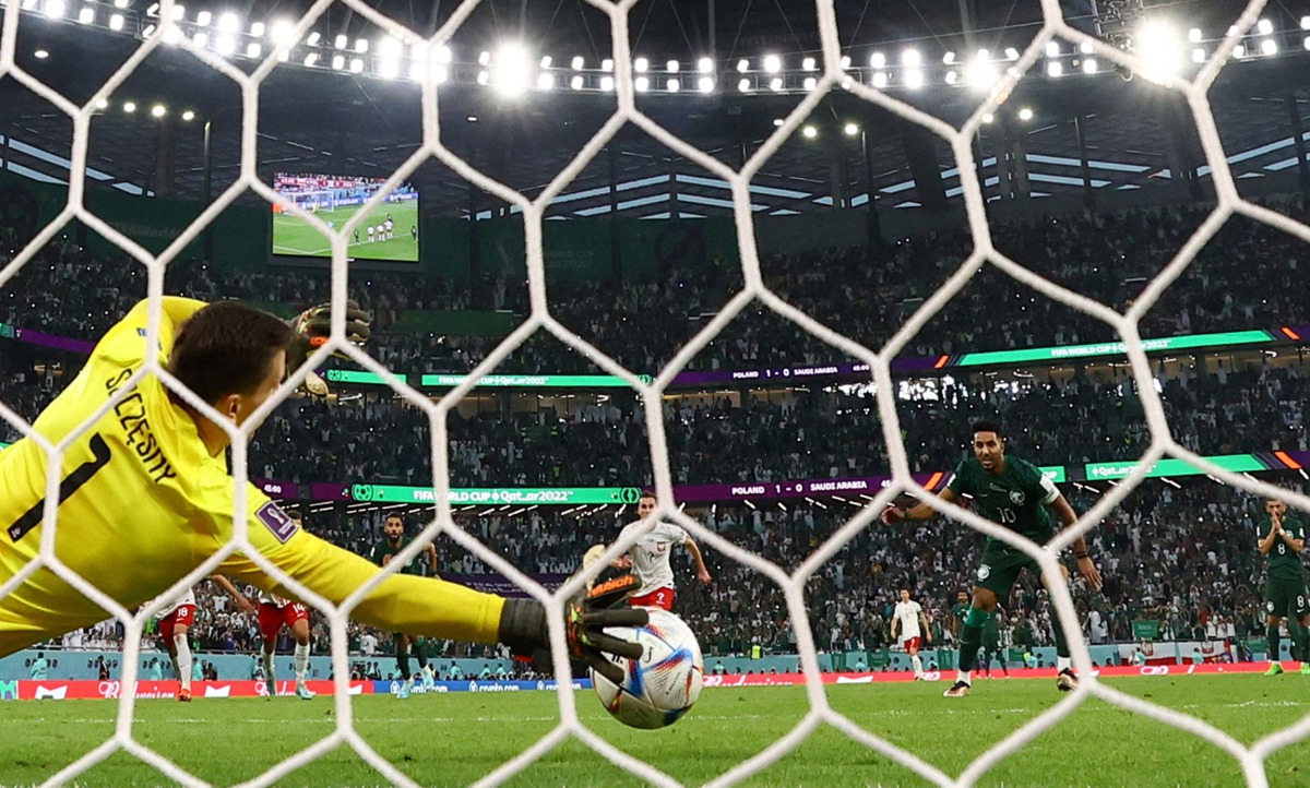 Poland’s Wojciech Szczesny saves a penalty from Saudi Arabia’s Salem Al Dawsari.