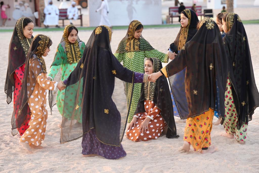 Children playing a traditional game at Darb Al Saai.