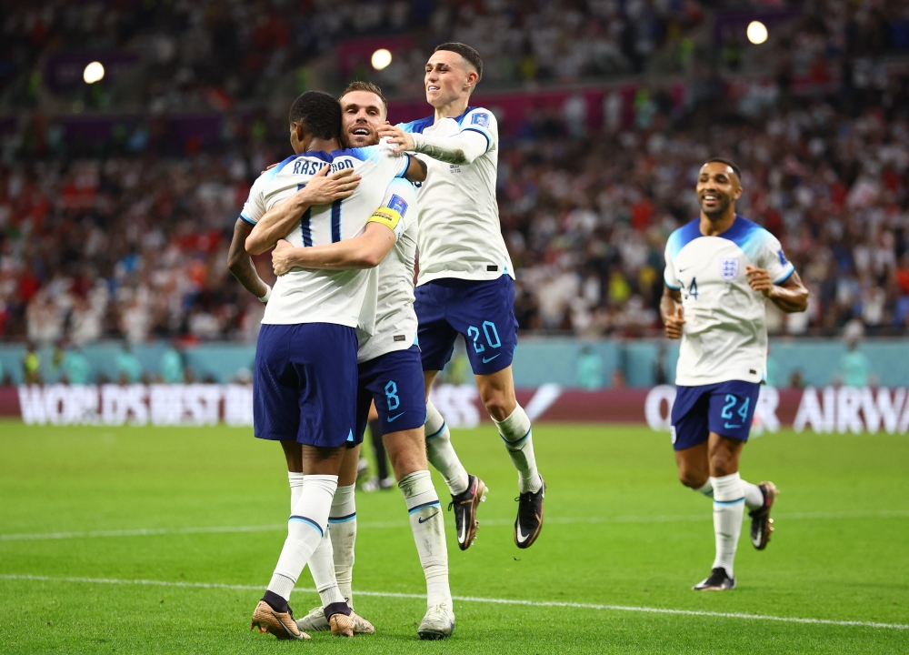 Marcus Rashford celebrates scoring their third goal with Jordan Henderson and Phil Foden during the Qatar World Cup Group B match against Wales at Ahmad Bin Ali Stadium on November 29, 2022. (REUTERS/Hannah Mckay)