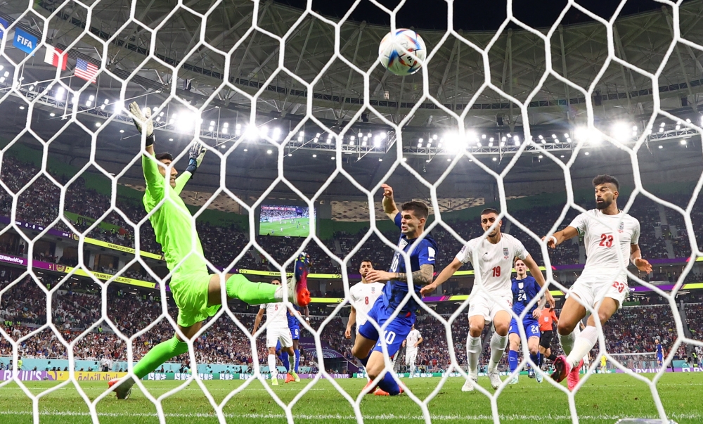 Christian Pulisic of the US scores the only goal of the FIFA World Cup Qatar 2022 Group B past Iran's Alireza Beiranvand at the Al Thumama Stadium, Doha, Qatar, on November 29, 2022. REUTERS/Kai Pfaffenbach