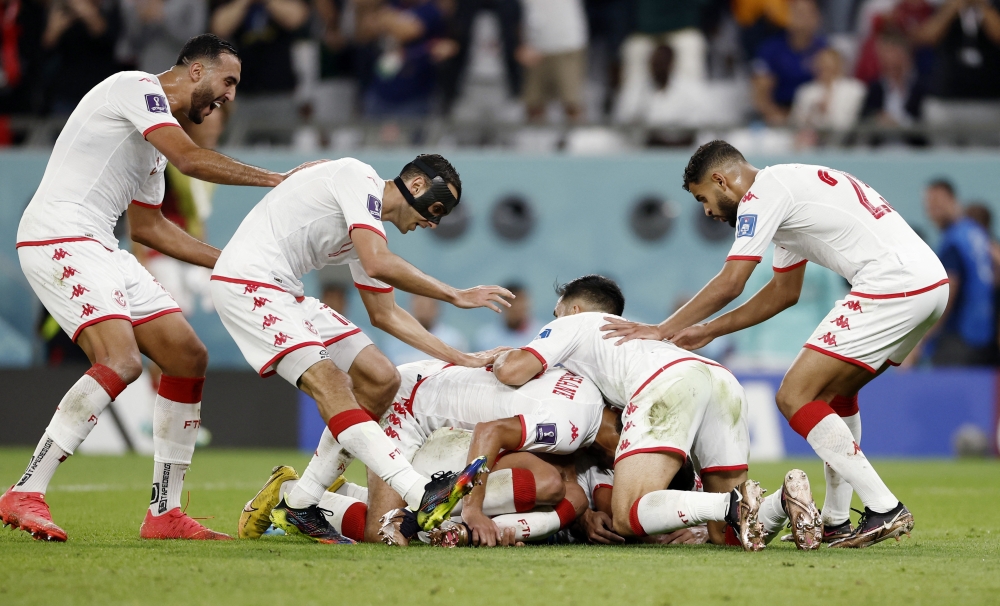 Tunisia's Wahbi Khazri celebrates scoring the only goal of the FIFA World Cup Qatar 2022 Group D match against France with teammates at the Education City Stadium, Al Rayyan, Qatar, on November 30, 2022.  REUTERS/Benoit Tessier