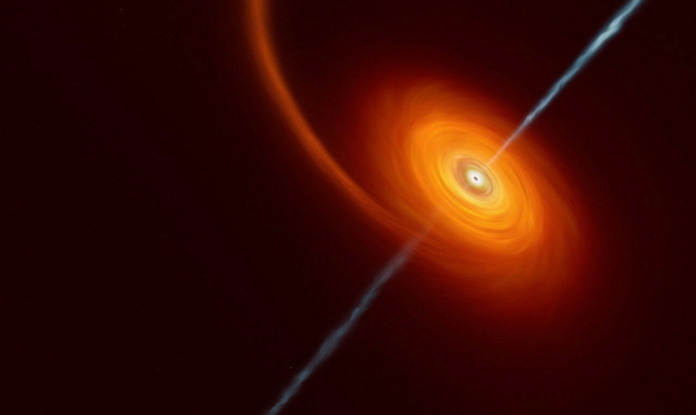 This undated artist’s impression illustrates how it might look when a star approaches too close to a black hole, where the star is squeezed by the intense gravitational pull of the black hole. Some of the star’s material gets pulled in and swirls around the black hole forming the disc that can be seen in this image. In rare cases, such as this one, jets of matter and radiation are shot out from the poles of the black hole. (ESO/M.Kornmesser/Handout via REUTERS)