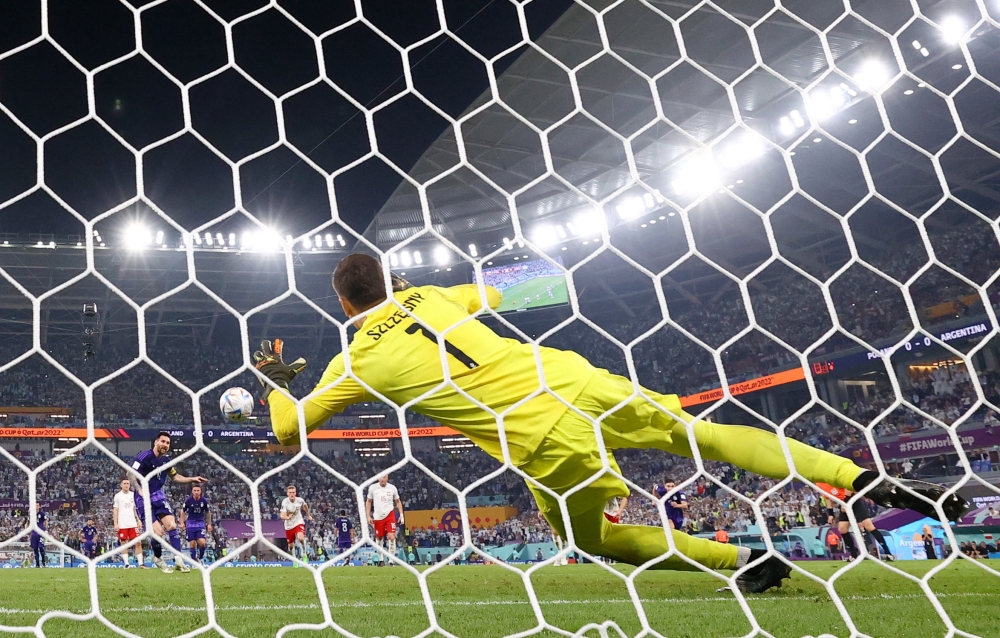 November 30, 2022 Poland's Wojciech Szczesny saves a penalty from Argentina's Lionel Messi REUTERS/Pedro Nunes