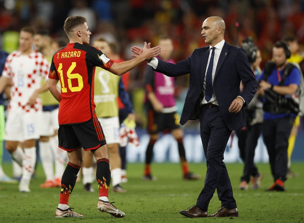 Belgium coach Roberto Martinez shakes hands with Thorgan Hazard after the match against Croatia, as Belgium are eliminated from the World Cup, at the Ahmad Bin Ali Stadium, Al Rayyan, Qatar, on December 1, 2022. REUTERS/John Sibley