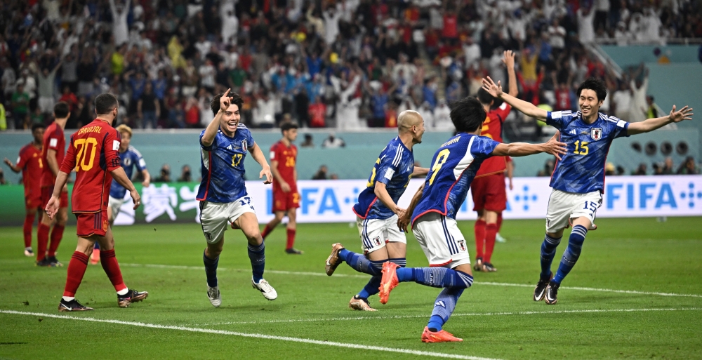 Japan's Ao Tanaka celebrates scoring their second goal with teammates during the Qatar World Cup final Group E match between Japan and Spain at Khalifa International Stadium on December 1, 2022. (REUTERS/Dylan Martinez)