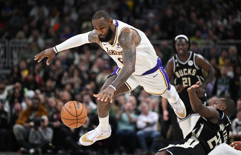 Los Angeles Lakers forward LeBron James (6) grabs the ball and jumps over Milwaukee Bucks forward Khris Middleton (22) in the second half at Fiserv Forum. Michael McLoone
