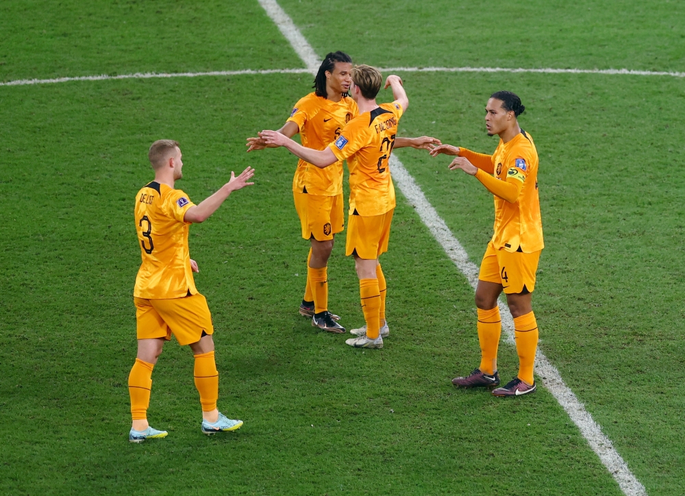 Netherlands' Virgil van Dijk, Matthijs de Ligt, Frenkie de Jong and Nathan Ake celebrates progressing to the quarter finals of FIFA World Cup Qatar 2022 at the Khalifa International Stadium, Doha, Qatar, on December 3, 2022 REUTERS/Lee Smith.