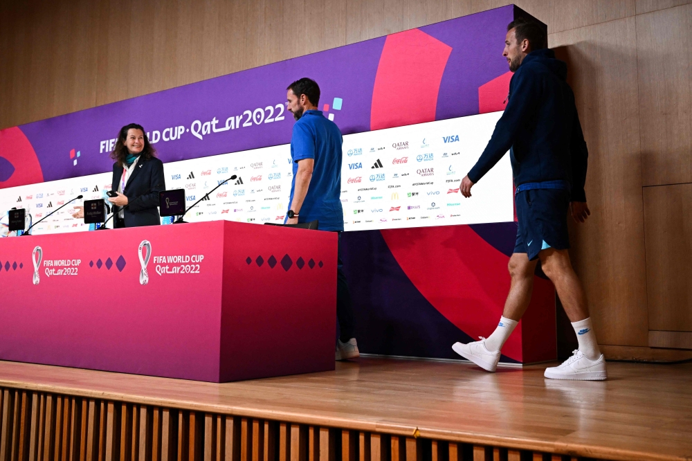 England's forward Harry Kane (right) and England's coach Gareth Southgate (centre) arrive for a press conference at the Qatar National Convention Center (QNCC) in Doha on Decmber 3, 2022 on the eve of the Qatar 2022 World Cup round of 16 football match between England and Senegal. (Photo by Paul ELLIS / AFP)