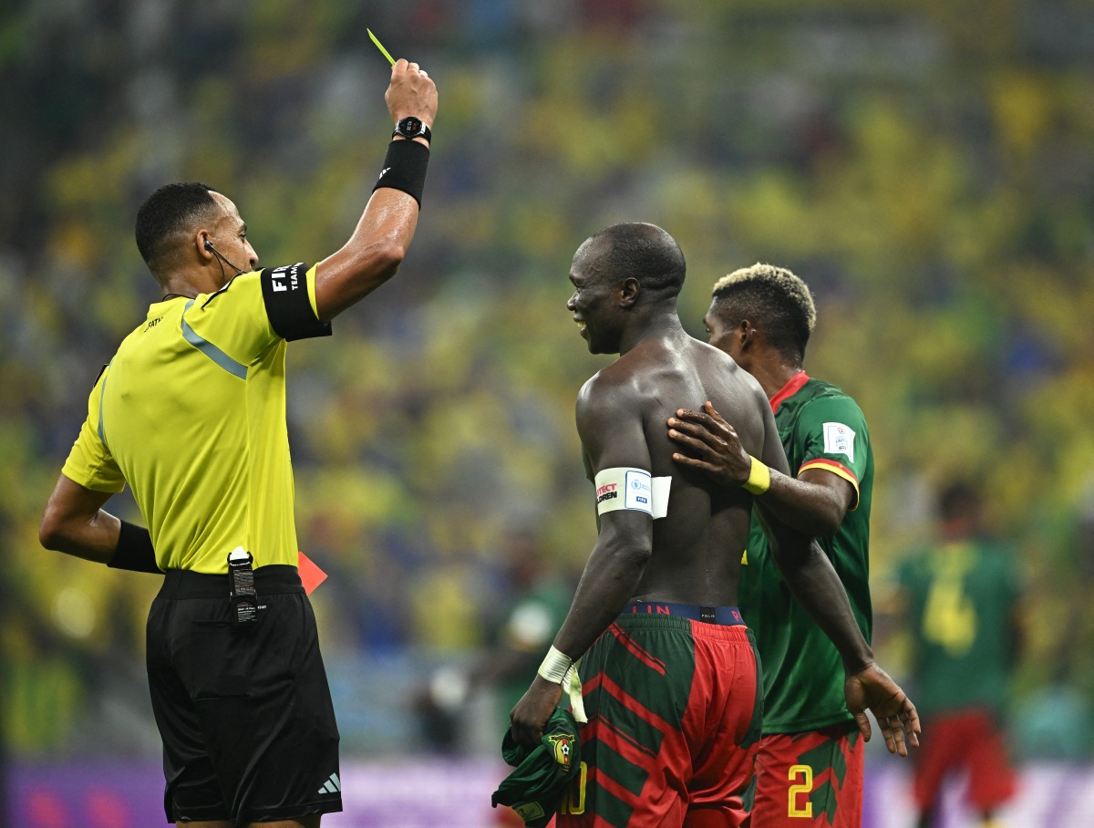 Cameroon’s Vincent Aboubakar is shown a second yellow and red card by referee Ismail Elfath for his shirtless celebration after scoring against Brazil at the Lusail Stadium on Friday. REUTERS