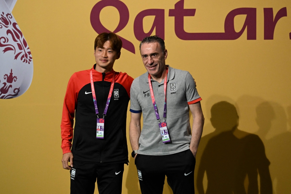 South Korea's defender Kim Jin-su and South Korea's Portuguese coach Paulo Bento ahead of a press conference at the Qatar National Convention Center (QNCC) in Doha on December 4, 2022, on the eve of the Qatar 2022 World Cup football match between Brazil and South Korea. (AFP/Pablo Porciuncula)