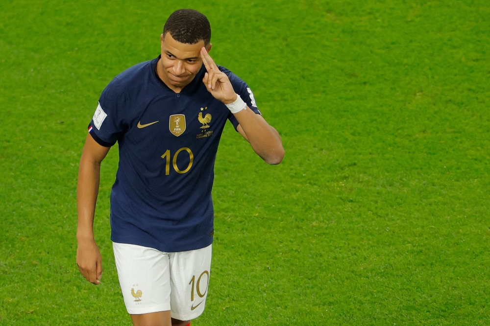 France's Kylian Mbappe celebrates scoring his team's third goal during the Qatar 2022 World Cup round of 16 football match between France and Poland at the Al Thumama Stadium in Doha on December 4, 2022. (AFP / Odd Andersen)