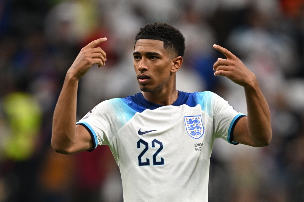 :England's midfielder #22 Jude Bellingham celebrates after qualifying to the next round by defeating Senegal 3-0 in the Qatar 2022 World Cup round of 16 football match between England and Senegal at the Al-Bayt Stadium in Al Khor, north of Doha on December 4, 2022. (Photo by Paul ELLIS / AFP)
