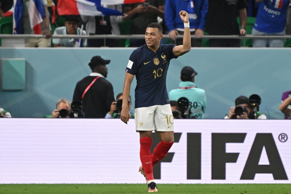 France's forward #10 Kylian Mbappe celebrates scoring his team's third goal during the Qatar 2022 World Cup round of 16 football match between France and Poland at the Al-Thumama Stadium in Doha on December 4, 2022. (Photo by ANDREJ ISAKOVIC / AFP)