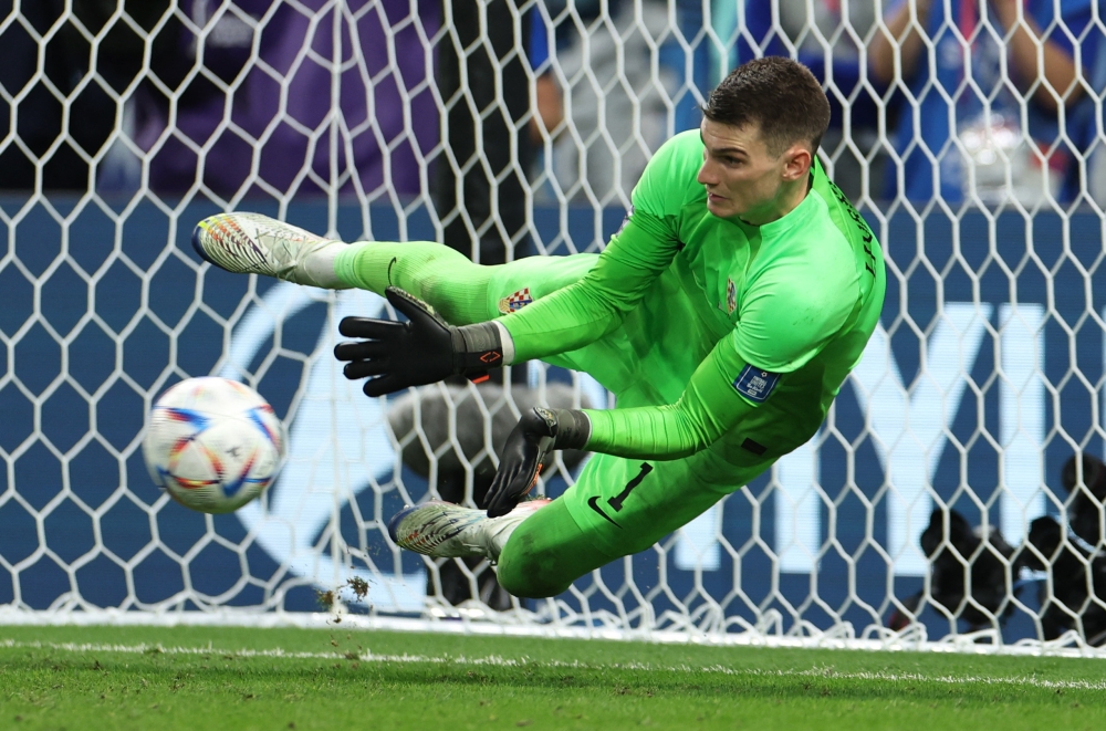 Croatia's Dominik Livakovic saves a penalty missed by Japan's Takumi Minamino during the FIFA World Cup Qatar 2022 Round of 16 match at the Al Janoub Stadium, Al Wakrah, Qatar, on December 5, 2022.  REUTERS/Marko Djurica