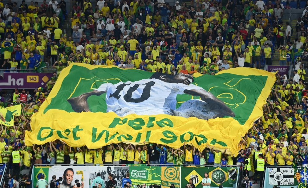 Fans inside the stadium hold up a banner of former Brazil player Pele with the message get well soon during the FIFA World Cup Qatar 2022 Round of 16 between Brazil and South Korea at Stadium 974, Doha, Qatar, on December 5, 2022. REUTERS/Annegret Hilse