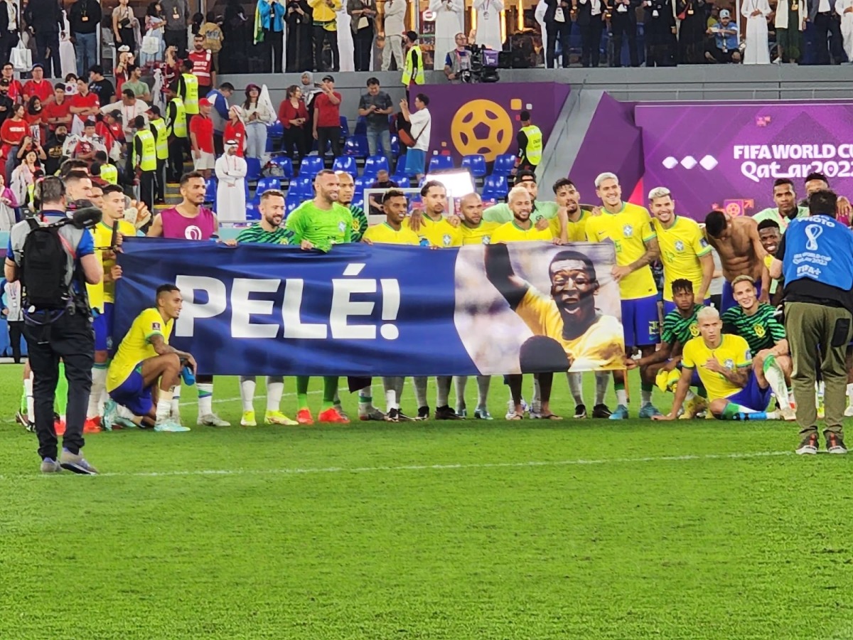 Brazil players pose for photo behind a large banner of Pele after their FIFA World Cup Qatar 2022 Round of 16 win over South Korea at the Stadium 974 in Doha on December 5, 2022.  Photo: Abdul Basit / The Peninsula