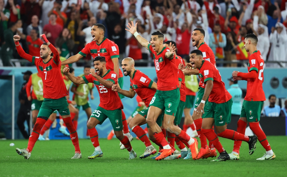 Morocco players celebrate after Achraf Hakimi scores the winning goal during the penalty shootout of the FIFA World Cup Qatar 2022 Round of 16 match against Spain at the Education City Stadium, Al Rayyan, Qatar, on December 6, 2022.  Reuters/Wolfgang Rattay