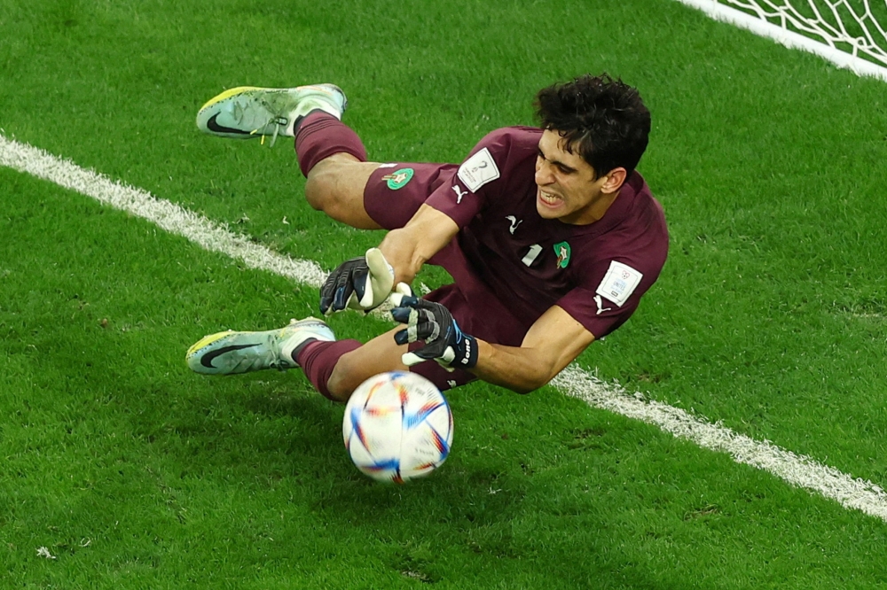 Morocco's Yassine Bounou saves a penalty missed by Spain's Carlos Soler during the FIFA World Cup Qatar 2022 Round of 16 match against Spain at the Education City Stadium, Al Rayyan, Qatar, on December 6, 2022.  REUTERS/Lee Smith