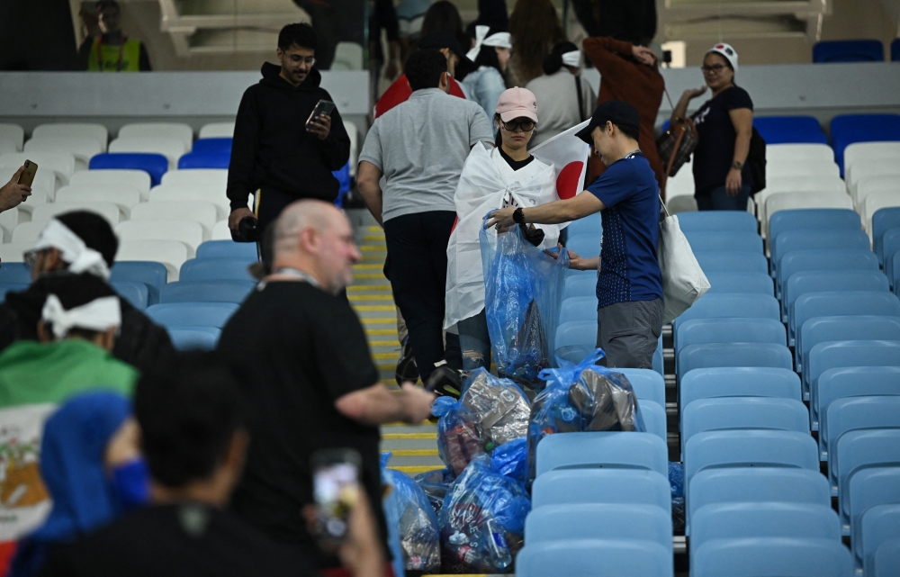 Japan fans clean up after the penalty shootout as Japan are eliminated from the World Cup. (REUTERS)