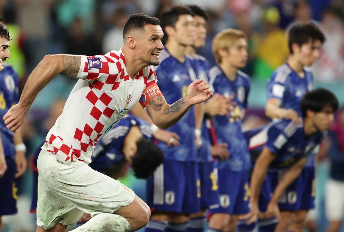 Croatia's Dejan Lovren celebrate qualifying for the quarter finals, as Japan players look dejected after being eliminated from the FIFA World Cup Qatar 2022, at the Al Janoub Stadium, Al Wakrah, Qatar, on December 5, 2022.  REUTERS/Marko Djurica
 
