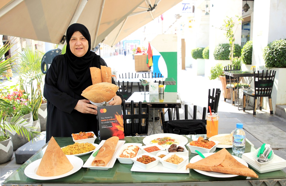 Chef Shams Al Qassabi with her specialities outside her restaurant at Souq Waqif. Pics: Salim Matramkot / The Peninsula