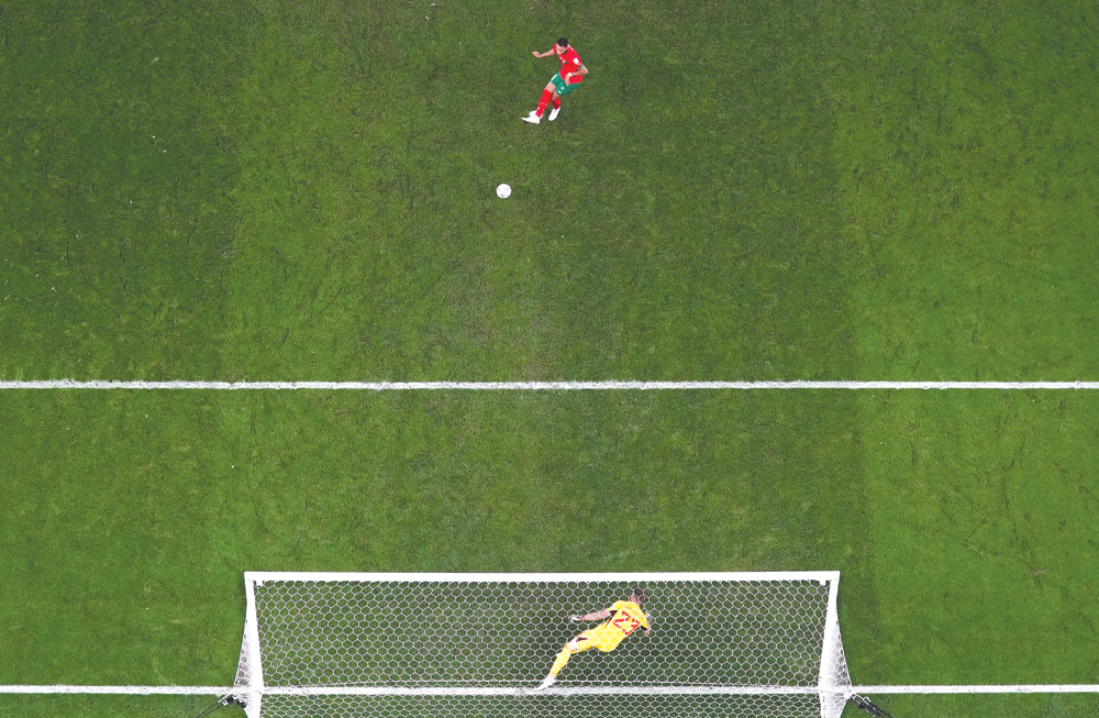 Morocco’s Abdelhamid Sabiri beats  Spain goalkeeper Unai Simón during their penalty shootout on Tuesday. REUTERS