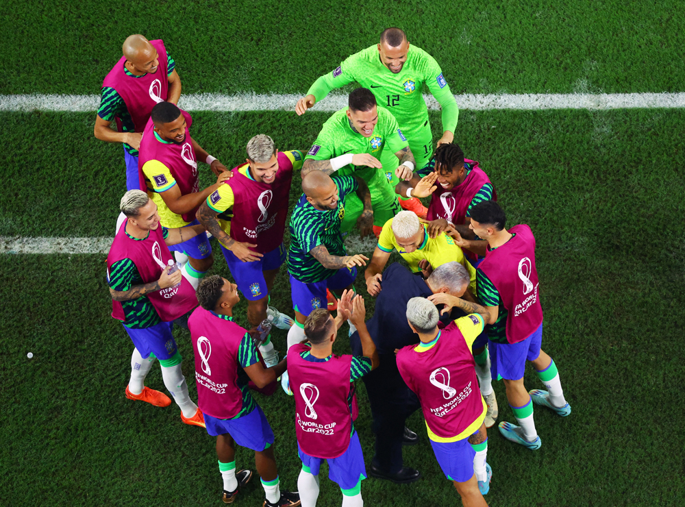 Brazil’s players dance with coach Tite as they celebrate a goal against South Korea on Monday. REUTERS