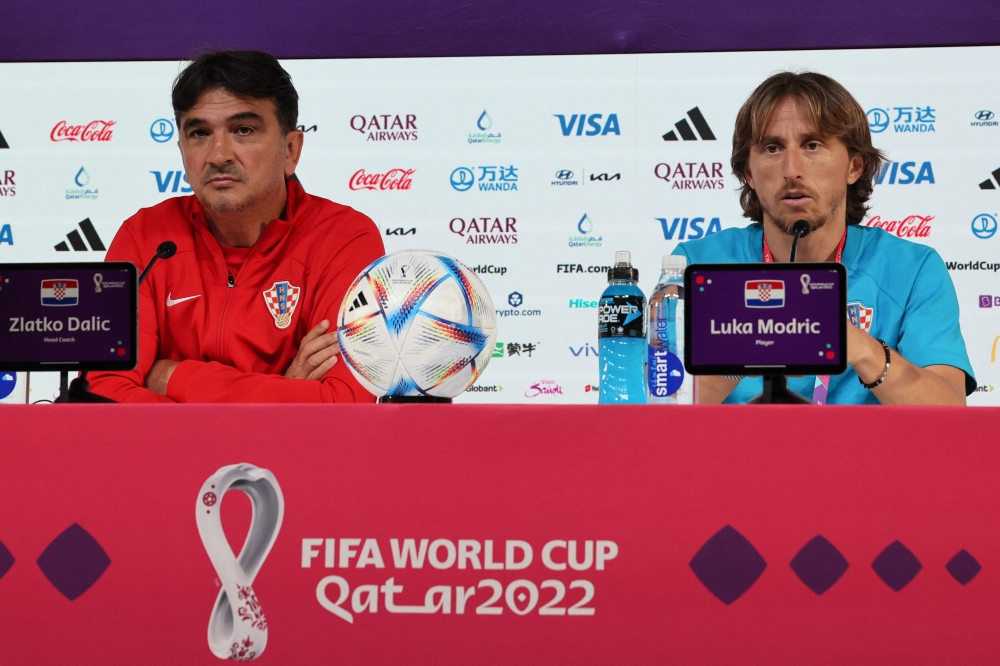 Croatia's coach Zlatko Dalic (left) and midfielder Luka Modric hold a press conference at the Qatar National Convention Center (QNCC) in Doha on December 8, 2022, on the eve of the Qatar 2022 World Cup quarter final football match between Brazil and Croatia. (Photo by JACK GUEZ / AFP)