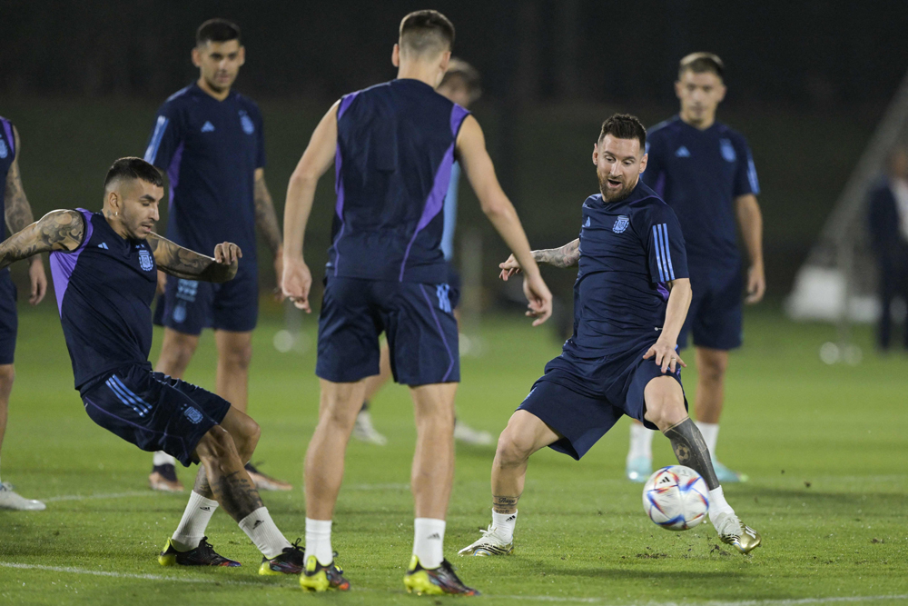 Argentina’s Angel Correa (left) and Lionel Messi (right) take part in a training session with teammates. AFP