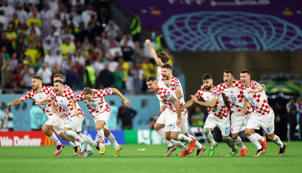 Croatia's players celebrate after winning the penalty shootout during the Qatar World Cup quarter-final match between Croatia and Brazil at the Education City Stadium on December 9, 2022. (REUTERS/Hannah Mckay)