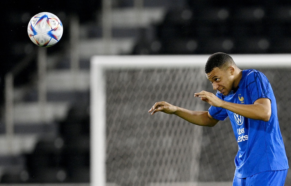 France’s forward Kylian Mbappe heads the ball during a training session. AFP