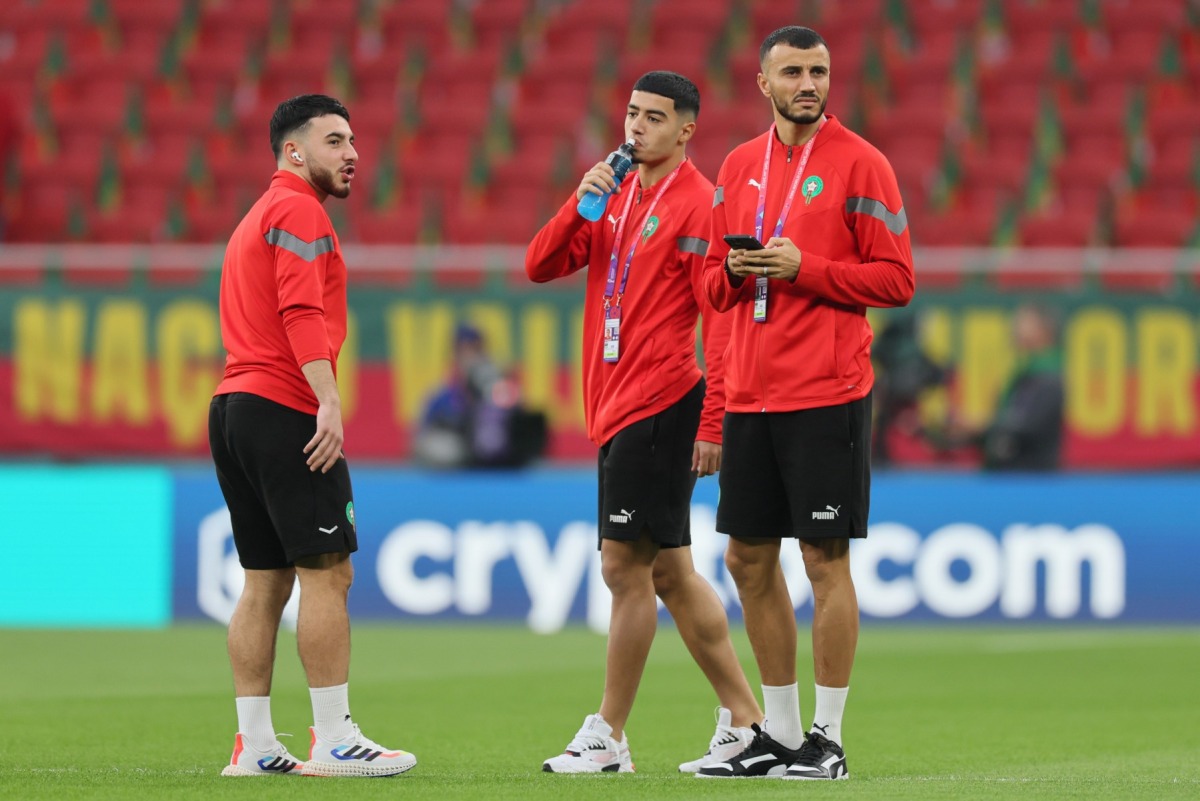 (From left) Morocco's midfielder #13 Ilias Chair, Morocco's forward #10 Anass Zaroury and Morocco's defender #06 Romain Ghanem Saiss inspect the pitch ahead of the Qatar 2022 World Cup quarter-final football match between Morocco and Portugal at the Al-Thumama Stadium in Doha on December 10, 2022. (Photo by KARIM JAAFAR / AFP)