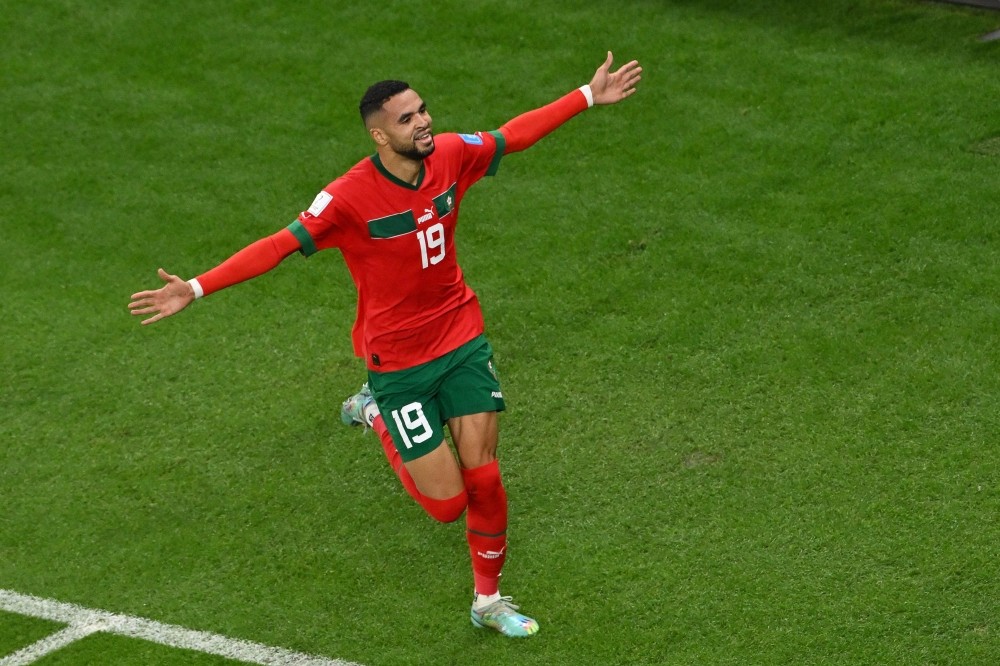 Morocco's forward #19 Youssef En-Nesyri celebrates scoring his team's first goal during the Qatar 2022 World Cup quarter-final football match between Morocco and Portugal at the Al-Thumama Stadium in Doha on December 10, 2022. (Photo by NELSON ALMEIDA / AFP)
