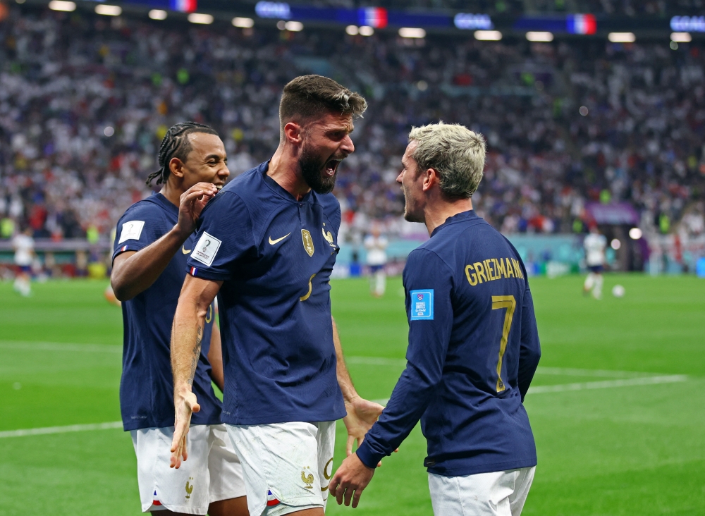 France's Olivier Giroud celebrates scoring their second goal with Antoine Griezmann and Jules Kounde during the FIFA World Cup Qatar 2022 quarter final match against England at the Al Bayt Stadium in Al Khor on December 10, 2022. REUTERS/Matthew Childs