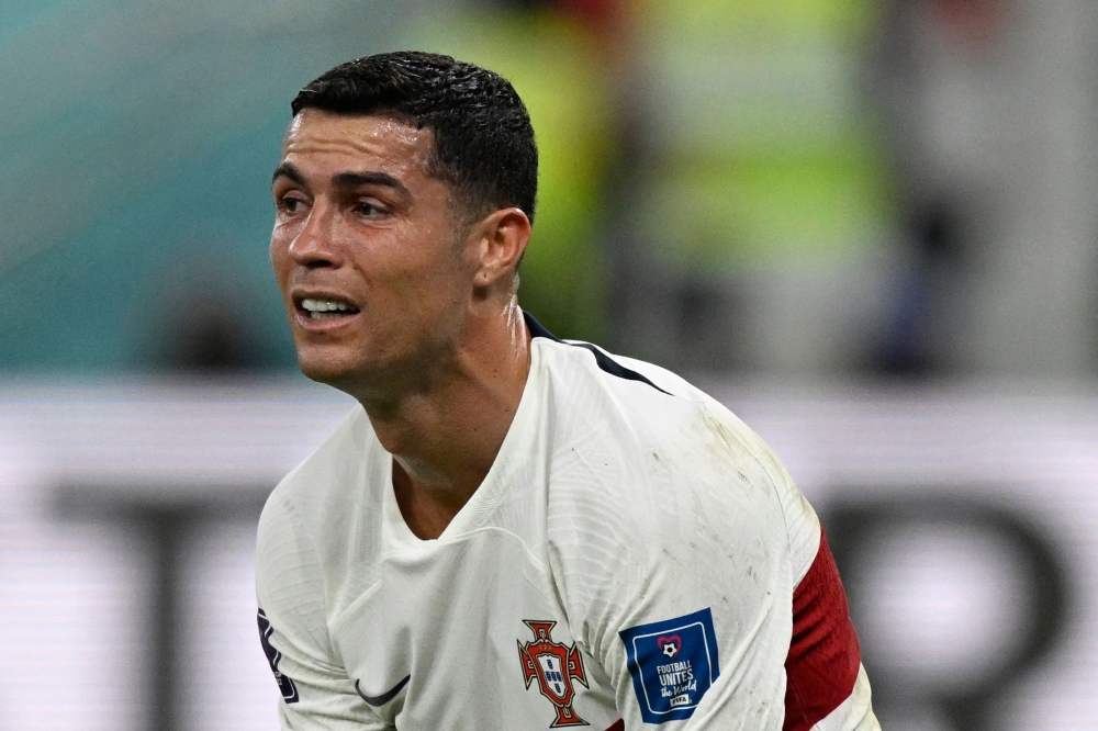 Portugal's forward #07 Cristiano Ronaldo reacts after his team lost the Qatar 2022 World Cup quarter-final football match between Morocco and Portugal at the Al-Thumama Stadium in Doha on December 10, 2022. (Photo by PATRICIA DE MELO MOREIRA / AFP)