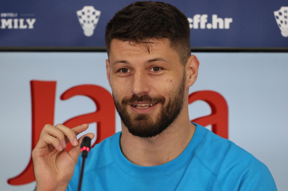 Croatia's forward Bruno Petkovic speaks during a press conference in Doha on December 11, 2022, ahead of their Qatar 2022 World Cup football semi-final match against Argentina. (Photo by JACK GUEZ / AFP)