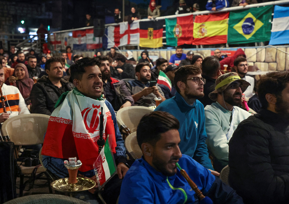 People gather as they watch FIFA World Cup Qatar 2022 match between Iran and United States in Beirut’s southern suburbs.