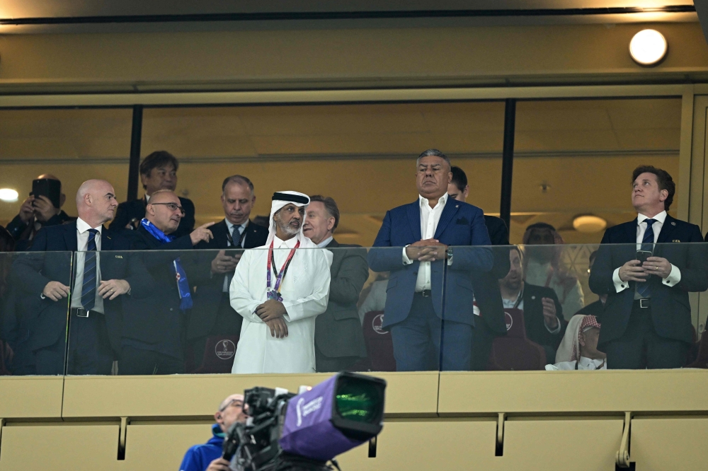 FIFA President Gianni Infantino, the president of the Qatar Football Association Hamad Bin Khalifa Bin Ahmed Al-Thani, the Argentine Football Association's (AFA) President Claudio Tapia and Conmebol's President Alejandro Dominguez wait for the start of the Qatar 2022 World Cup semi-final match between Argentina and Croatia at Lusail Stadium in Lusail on December 13, 2022. (Photo by JUAN MABROMATA / AFP)