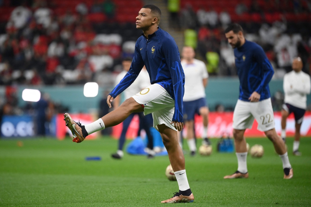 France's forward Kylian Mbappe warms up ahead of the Qatar 2022 World Cup semi-final football match between France and Morocco at the Al-Bayt Stadium in Al Khor, north of Doha on December 14, 2022. (Photo by FRANCK FIFE / AFP)