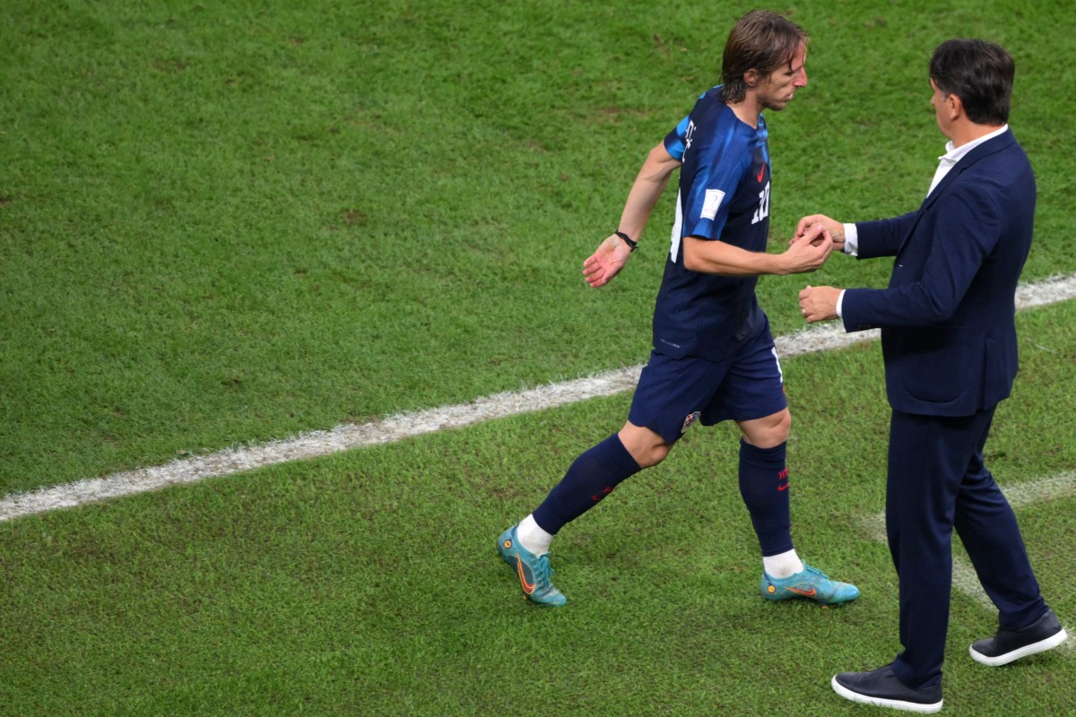 Croatia’s midfielder Luka Modric is greeted by coach Zlatko Dalic as he leaves the pitch. AFP