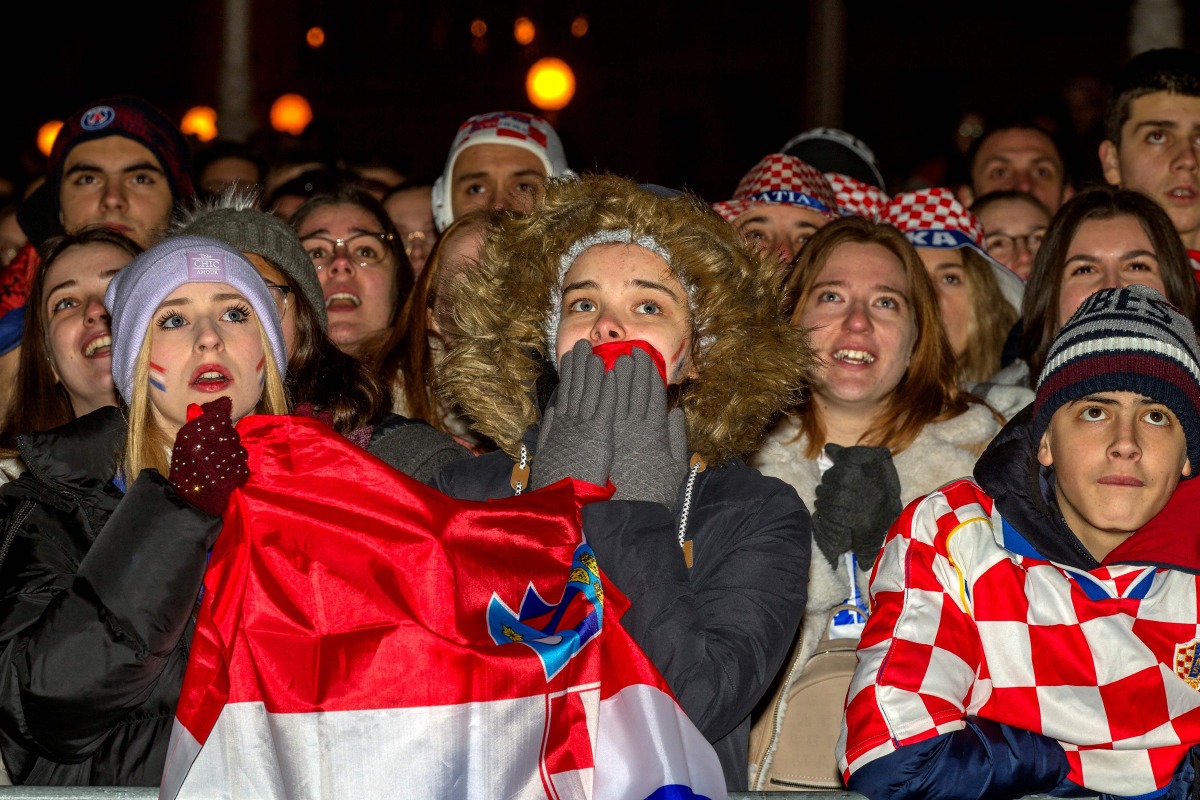 Spectators react as they watch the Qatar 2022 semi-final match between Argentina and Croatia, in the main square of Zagreb on Tuesday. AFP